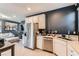 Kitchen featuring white cabinetry and stainless steel appliances, with an open view to the living room at 363 Silva Pl, Henderson, NV 89011
