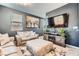 Stylish living room with ample seating, a media center, and natural light from the window at 363 Silva Pl, Henderson, NV 89011