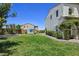 Spacious backyard with green lawn, a hot tub, and patio seating for outdoor enjoyment at 396 Blackstone River Ave, Las Vegas, NV 89148
