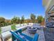 Beautiful backyard with a modern fire pit, comfortable seating, and well-manicured landscaping at 396 Blackstone River Ave, Las Vegas, NV 89148
