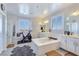 Bright bathroom features a soaking tub, double vanities, a shower, and a Peloton exercise bike at 396 Blackstone River Ave, Las Vegas, NV 89148