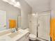 Modern bathroom with glass shower, neutral tiling, updated vanity, and ample lighting at 396 Blackstone River Ave, Las Vegas, NV 89148