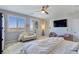 Bright bedroom features a sitting area and TV; two large windows let in plenty of natural light at 396 Blackstone River Ave, Las Vegas, NV 89148