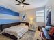 Comfortable bedroom with blue and white accents, plush bedding, and ample closet space at 396 Blackstone River Ave, Las Vegas, NV 89148