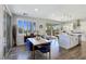 Inviting dining area with wood floors, modern blue chairs, and sliding door access to the outdoor area at 396 Blackstone River Ave, Las Vegas, NV 89148