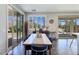 Bright dining area featuring stylish blue chairs, wood floors and views of the outdoor living space at 396 Blackstone River Ave, Las Vegas, NV 89148