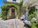 Inviting front porch with gray Adirondack chairs, lush plants and beautiful pavers near the front door at 396 Blackstone River Ave, Las Vegas, NV 89148