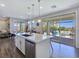 Open-concept kitchen with a center island, stainless steel appliances, and views of the outdoor living area at 396 Blackstone River Ave, Las Vegas, NV 89148