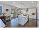 Modern kitchen featuring white cabinets, a large island, and stainless steel appliances with outdoor access at 396 Blackstone River Ave, Las Vegas, NV 89148