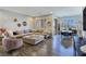 Spacious living room featuring stylish decor, a comfortable sectional sofa, and wood-look tile flooring at 396 Blackstone River Ave, Las Vegas, NV 89148