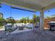 Inviting covered patio with comfortable seating around a modern fire pit and stylish decor at 396 Blackstone River Ave, Las Vegas, NV 89148