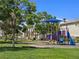 A colorful playground with slide, play structure and plenty of mature shade trees at 396 Blackstone River Ave, Las Vegas, NV 89148