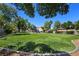 A well-maintained community playground with open green space and mature shade trees at 396 Blackstone River Ave, Las Vegas, NV 89148