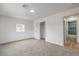 Bedroom featuring carpet, a flush ceiling light, and an open door to the bathroom at 40 Laswell St, Henderson, NV 89015