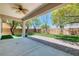 Expansive backyard featuring a covered patio, artificial turf, and mature landscaping for outdoor enjoyment at 42 Glade Water Dr, Henderson, NV 89052