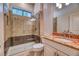 Modern bathroom showcasing glass-enclosed shower with tiled walls and a granite vanity at 42 Glade Water Dr, Henderson, NV 89052