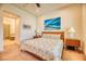 This bedroom showcases a neutral color palette, carpet flooring and an en-suite bathroom with walk-in closet at 42 Glade Water Dr, Henderson, NV 89052