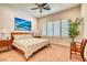 Bright bedroom features plantation shutters, ceiling fan, and a king-size bed with a beautiful ocean artwork at 42 Glade Water Dr, Henderson, NV 89052