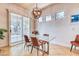 Elegant dining area featuring a modern chandelier and sliding glass door to the backyard at 42 Glade Water Dr, Henderson, NV 89052