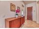 Beautiful foyer with modern wood console, striking artwork, and an elegant wood front door at 42 Glade Water Dr, Henderson, NV 89052
