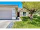 Charming single-story home featuring a well-maintained front yard, two car garage and desert landscaping at 42 Glade Water Dr, Henderson, NV 89052