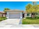 Inviting single-story home featuring a two-car garage, desert landscaping, and a cozy, covered entrance at 42 Glade Water Dr, Henderson, NV 89052