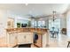 Open-concept kitchen with granite counters, stainless steel appliances, and an island overlooking the living area at 42 Glade Water Dr, Henderson, NV 89052