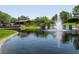 Picturesque view of a pond with a fountain and a charming gazebo at 42 Glade Water Dr, Henderson, NV 89052