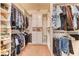Organized walk-in closet providing ample storage space with custom shelving and hanging rods at 42 Glade Water Dr, Henderson, NV 89052