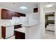 Stylish kitchen with granite countertops and modern white appliances with view of the bedroom at 4200 S Valley View Blvd # 2009, Las Vegas, NV 89103