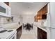Modern kitchen with white appliances and granite countertops with a view to dining area at 4200 S Valley View Blvd # 2009, Las Vegas, NV 89103