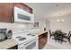 Modern kitchen featuring white appliances and a view of the dining area at 4200 S Valley View Blvd # 2009, Las Vegas, NV 89103