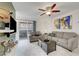 Living room with marble floors, ceiling fan, and sliding door access to outdoor balcony at 4200 S Valley View Blvd # 2009, Las Vegas, NV 89103