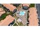 An aerial view showcases the community pool and surrounding condo buildings with terracotta roofs at 4200 S Valley View Blvd # 3074, Las Vegas, NV 89103