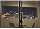 Balcony view of city skyline at night with table and chairs at 4200 S Valley View Blvd # 3074, Las Vegas, NV 89103