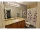 Bathroom with a granite countertop, under sink wood cabinet and shower/tub combination at 4200 S Valley View Blvd # 3074, Las Vegas, NV 89103