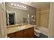 Bathroom featuring a granite countertop, wood cabinet and shower/tub combination at 4200 S Valley View Blvd # 3074, Las Vegas, NV 89103