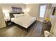 Comfortable bedroom with a king-sized bed, wood-look floors, and modern décor at 4200 S Valley View Blvd # 3074, Las Vegas, NV 89103