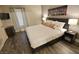 Cozy bedroom with modern decor, wood-look floors, and a comfortable king-sized bed at 4200 S Valley View Blvd # 3074, Las Vegas, NV 89103