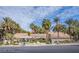 Exterior shot of the clubhouse, surrounded by lush landscaping with palm trees at 4200 S Valley View Blvd # 3074, Las Vegas, NV 89103