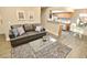 Cozy living room with a comfortable sofa, modern coffee table, and an open view into the kitchen and dining area at 4200 S Valley View Blvd # 3074, Las Vegas, NV 89103