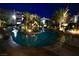 Nighttime view of community pool showcasing ambient lighting and tropical landscaping at 4200 S Valley View Blvd # 3074, Las Vegas, NV 89103