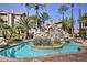Beautiful tropical pool with rock waterfall feature surrounded by palm trees and lush landscaping at 4200 S Valley View Blvd # 3074, Las Vegas, NV 89103