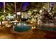 Inviting pool with tropical rock waterfall, surrounded by lush landscaping and ambient lighting at 4200 S Valley View Blvd # 3074, Las Vegas, NV 89103