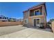Backyard with a concrete patio, gravel area, grill, and tall brick wall with the house in the background at 4240 Spring Storm Ave, North Las Vegas, NV 89081