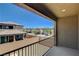 View from a balcony of a community with two-story homes, sidewalks, and desert landscaping at 4240 Spring Storm Ave, North Las Vegas, NV 89081