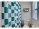 Bathroom with a shower featuring checkered curtains, a toilet, and a storage rack at 4240 Spring Storm Ave, North Las Vegas, NV 89081