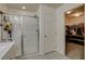 Bathroom featuring a glass enclosed shower and access to a walk-in closet with custom shelving at 4240 Spring Storm Ave, North Las Vegas, NV 89081