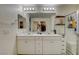 Bathroom with double sinks, a large mirror, and white cabinets at 4240 Spring Storm Ave, North Las Vegas, NV 89081
