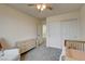 Cozy bedroom featuring neutral walls, ceiling fan, and closet at 4240 Spring Storm Ave, North Las Vegas, NV 89081